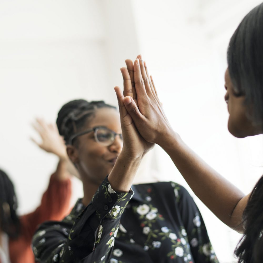 Businesswomen giving each other a high five